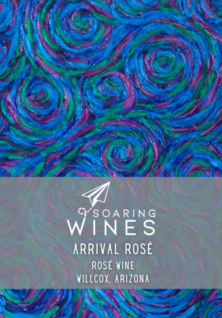 Wine label for Soaring Wines Arrival Rosé Wine from Willcox, Arizona, featuring vibrant blue, purple, and green swirling patterns with white typography and paper airplane logo on artistic background.