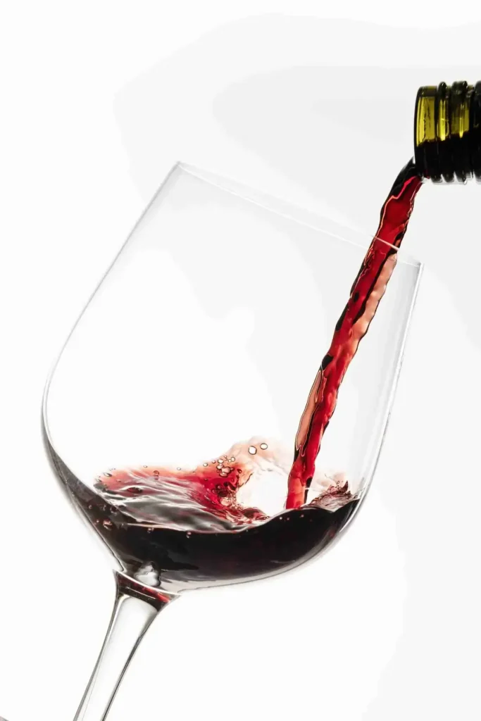 Red wine pouring into glass, Soaring Wines enjoyment